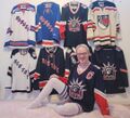 Kris in thighhighs, posing next to his plethora of NYR merch